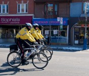 Three police cyclists in a line on Danforth Avenue, Toronto 2011-03-27