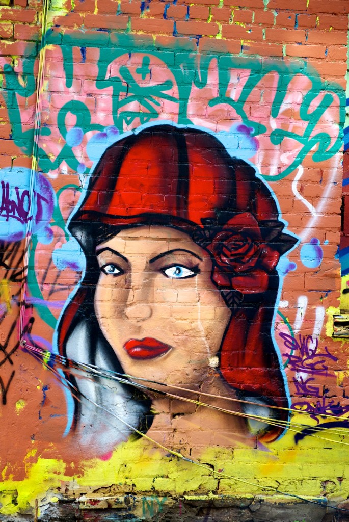 Woman wearing red hat in alleyway behind Queen Street West, Toronto 2011-05-26