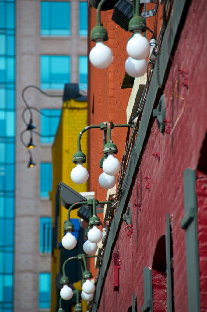 A view of light fixtures looking up Leader Lane from Wellington Street East, Toronto 