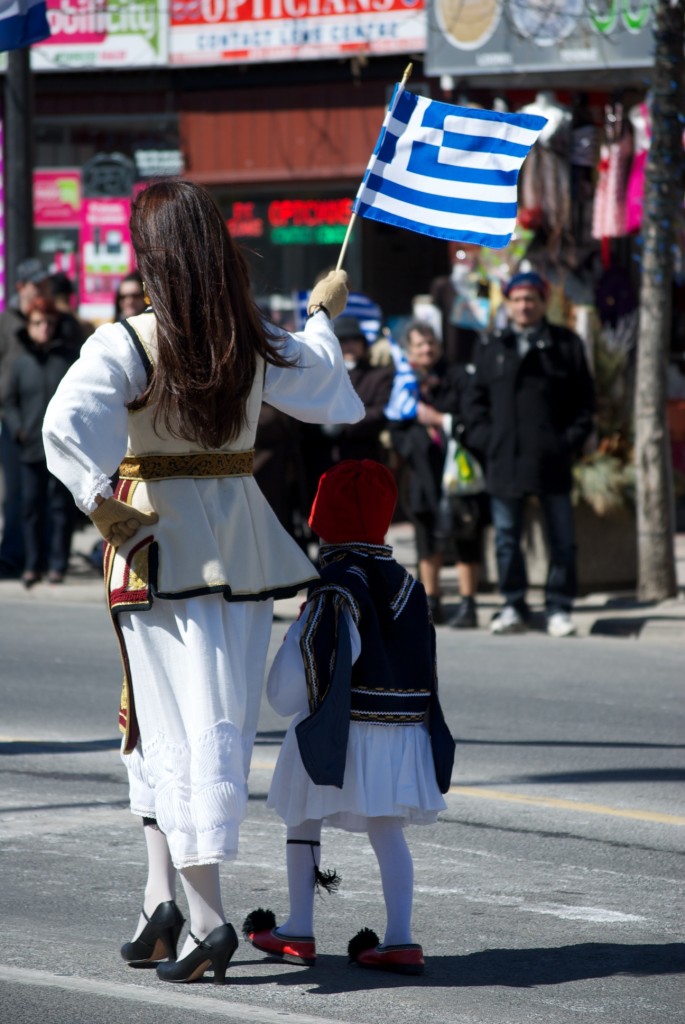 Greek flag held by marcher in the Greek Independence Parade on Danforth Avenue Toronto 2011-03-27