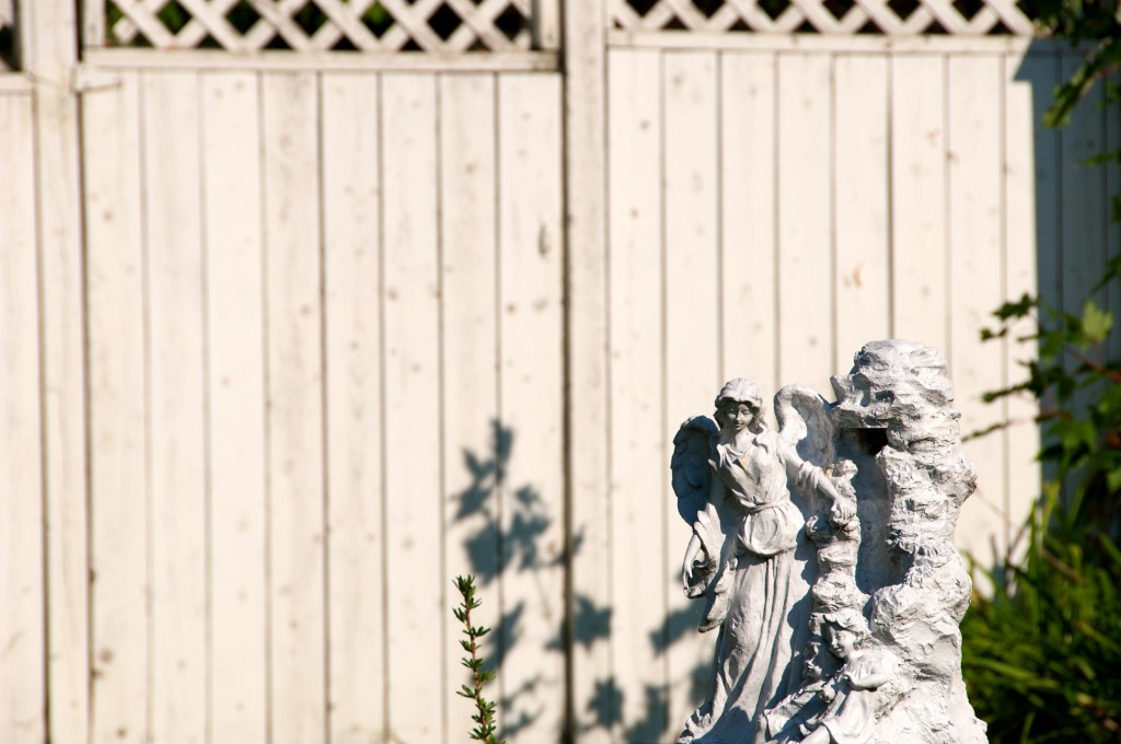 Statue in front of a white fence in Dorval 2012-09-11